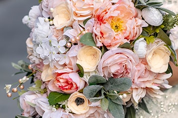 A bouquet of flowers featuring a variety of roses and other decorative flowers
