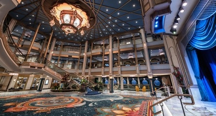 A large ornate chandelier inside the Grand Hall on board the Disney Wish cruise ship
