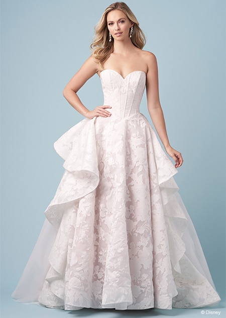 A bride wearing a strapless Rapunzel themed ball gown featuring a sweetheart neckline