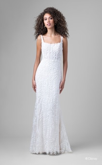 A bride wearing a Pocahontas inspired sheath gown featuring a square neckline and leaf detail using lace and sequins