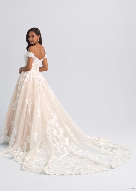 The back of an off the shoulder and lacy wedding dress featuring a long train inspired by Snow White