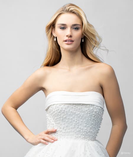 The bodice of a bride wearing an Ariel inspired ball gown featuring a straight neckline and a beaded bodice