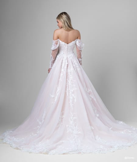 The back of a bride wearing an Aurora inspired A line gown featuring off the shoulder sleeves and lace detail