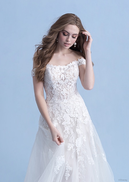 A side view of a woman in the Aurora wedding gown from the 2021 Disney Fairy Tale Weddings Collection