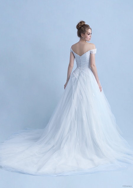 A back side view of a woman wearing the Cinderella wedding gown from the 2021 Disney Fairy Tale Weddings Collection