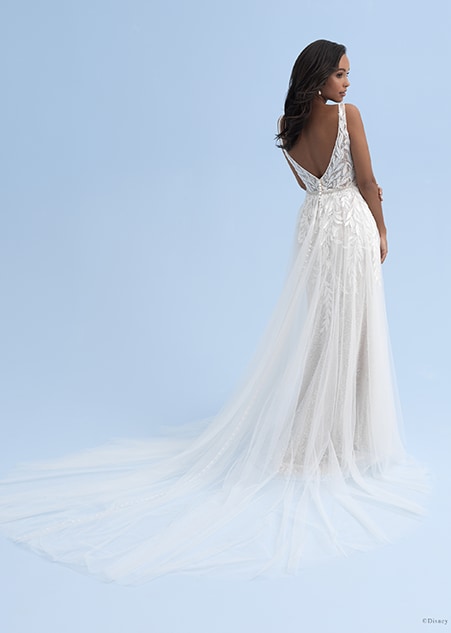 The back view of a woman in a wedding dress with a low back and a long train