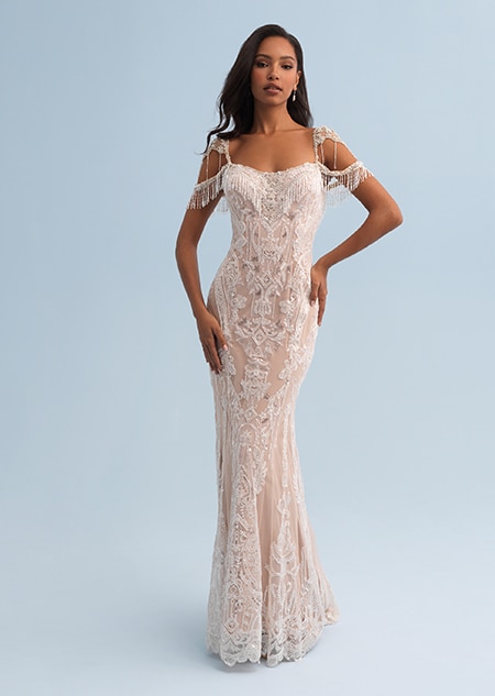 A bride in a form fitting wedding dress with a square neckline decorated with crystal flowers