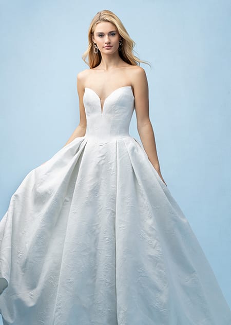 The front of a bride wearing a Cinderella inspired ball gown featuring a sweetheart neckline