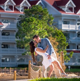 A man and woman embrace and kiss by Disney's Grand Floridian Resort & Spa