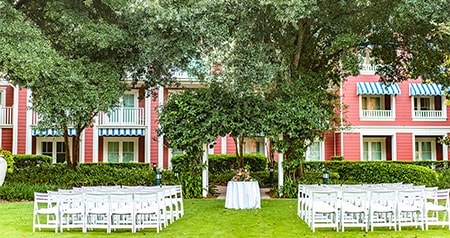 Rows of chairs are set up on a lawn for a wedding ceremony at Disney’s Boardwalk Inn