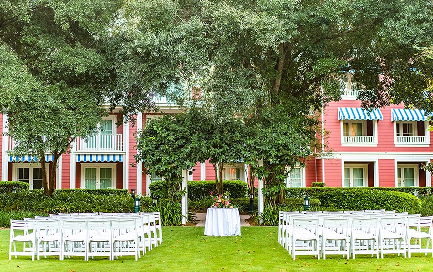 Rows of chairs are set up on a lawn for a wedding ceremony at Disney’s Boardwalk Inn 
