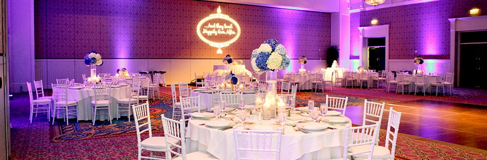 The words 'and they lived happily ever after' projected on a wall in a reception hall
