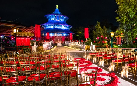 A wedding ceremony setting decorated with candles and an aisle of rose petals at the China Pavilion 
