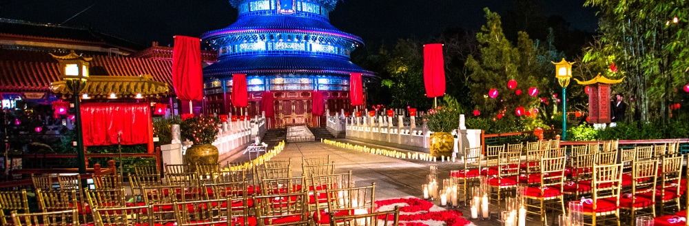 A wedding ceremony setting decorated with candles and an aisle of rose petals at the China Pavilion