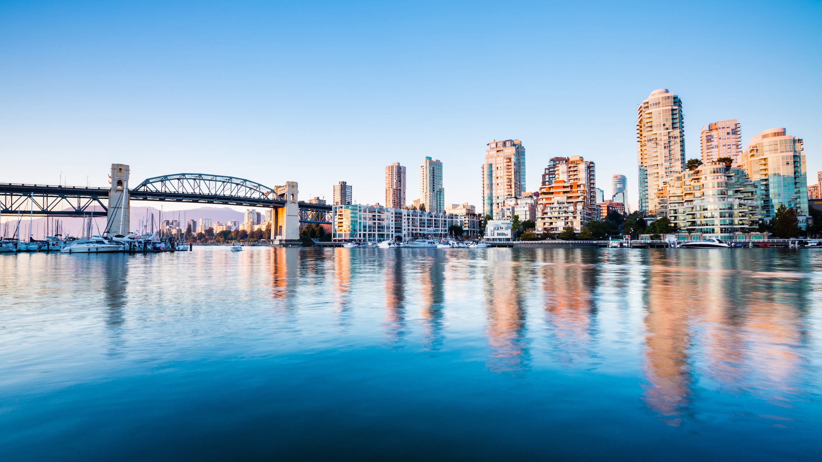 A waterfront cityscape featuring a bridge A waterfront cityscape featuring a bridge
