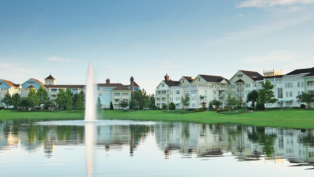 Disney's Saratoga Springs Resort & Spa by a lake with a fountain feature
