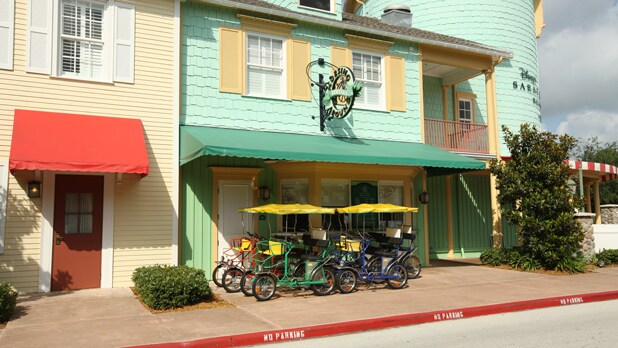Surrey bikes under the awning in front of a shop