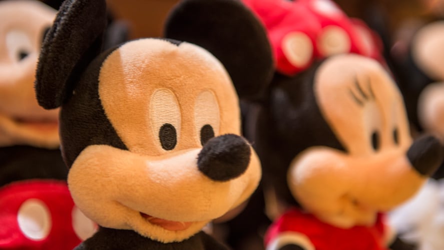 A plush Mickey Mouse next to a plush Minnie Mouse