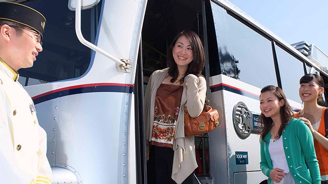 A woman boarding a bus at Tokyo Disney Resort