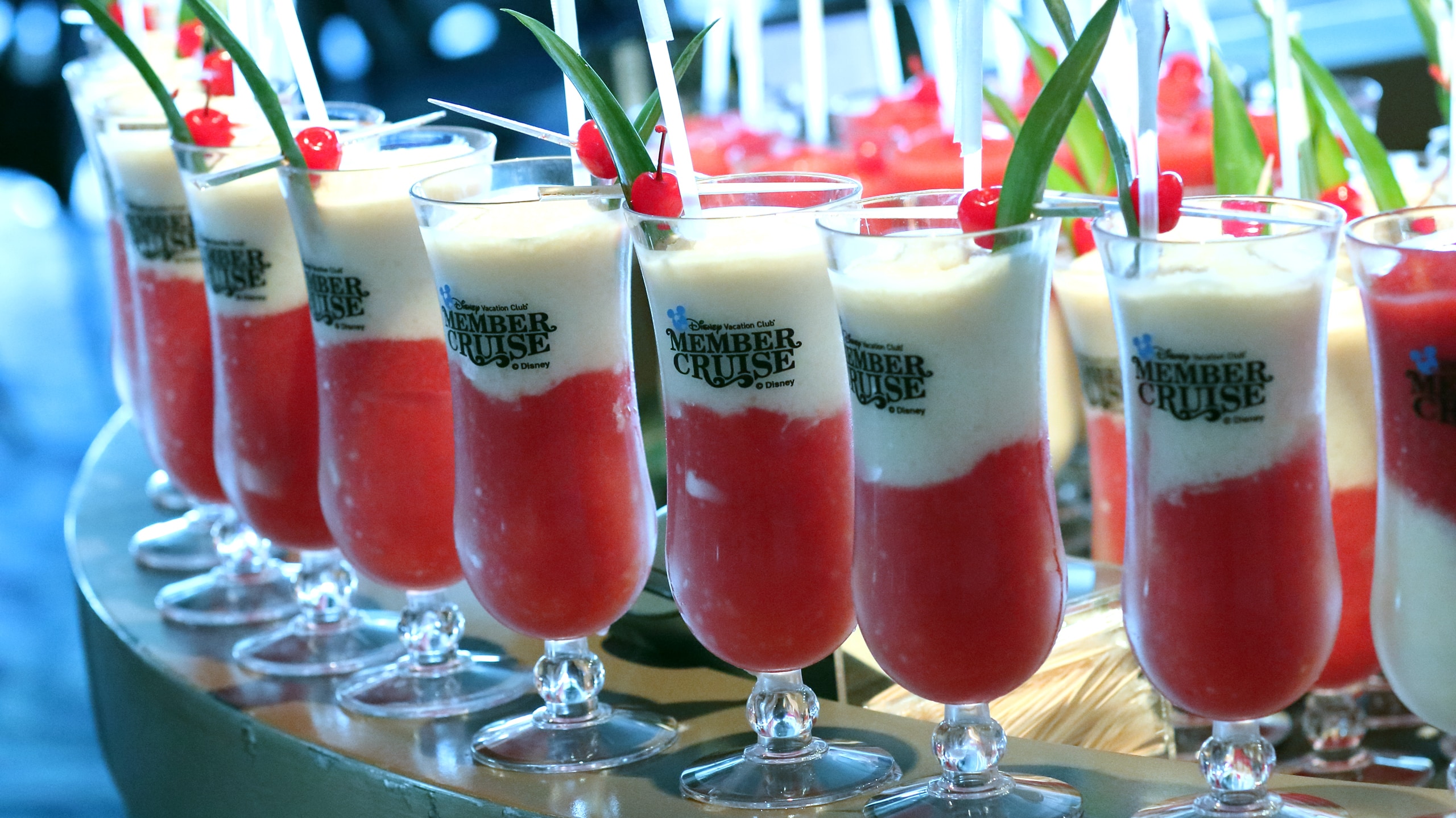 Tropical frozen cocktails in glasses that feature the Disney Vacation Club Member Cruise logo