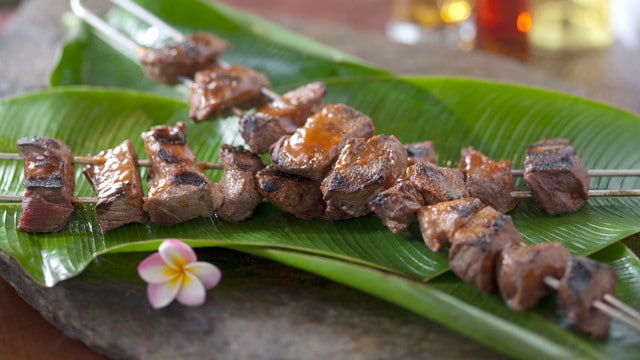 Beef kabobs served on palm fronds