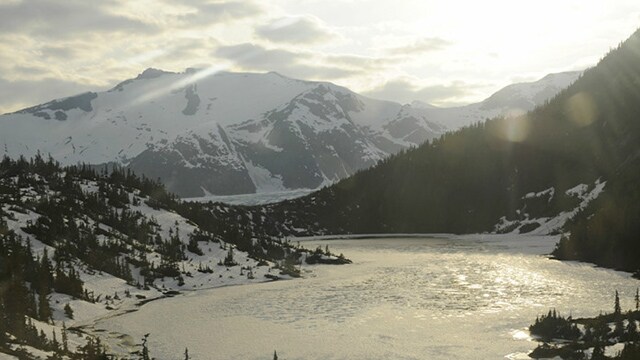 An icy lake surrounded by snowcapped mountains