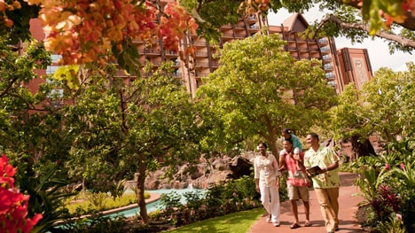A Cast Member leads a family on a tour around the grounds at Aulani, A Disney Resort & Spa