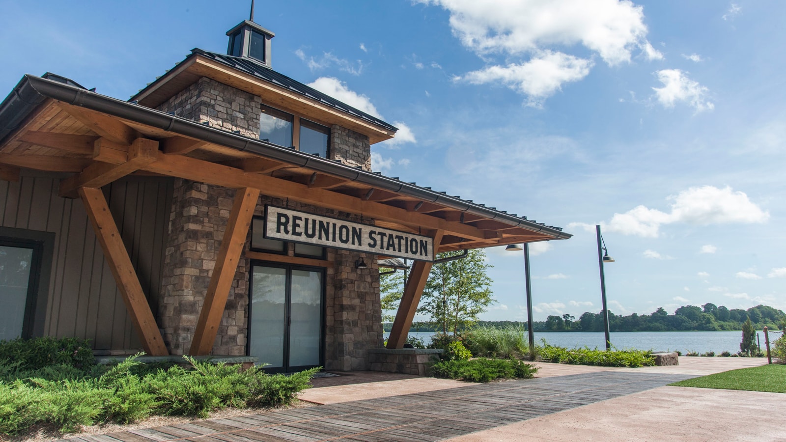 A wood and stone building with a sign that reads 'Reunion Station'