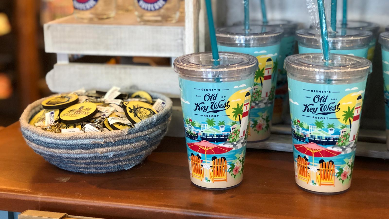 Disney’s Old Key West Resort tumblers and straws and a bowl full of Resort key chains