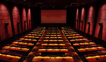 AMC Movies at Disney Springs 24 Stadium seats with tables inside at a movie theatre at AMC Disney Springs 24 Theatres