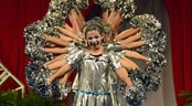 Pop Warner National Cheer & Dance Championships Teammates stand behind a cheerleader and shake their pom-poms, making her appear to have several arms