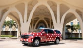 A minivan with polka dots and a Minnie icon under the port cochère of Disney’s Coronado Springs Resort 