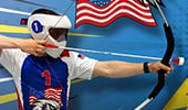 An Archery Tag player wearing a helmet and drawing back an arrow on his bow