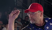 A contestant preparing to throw a BullShooter dart
