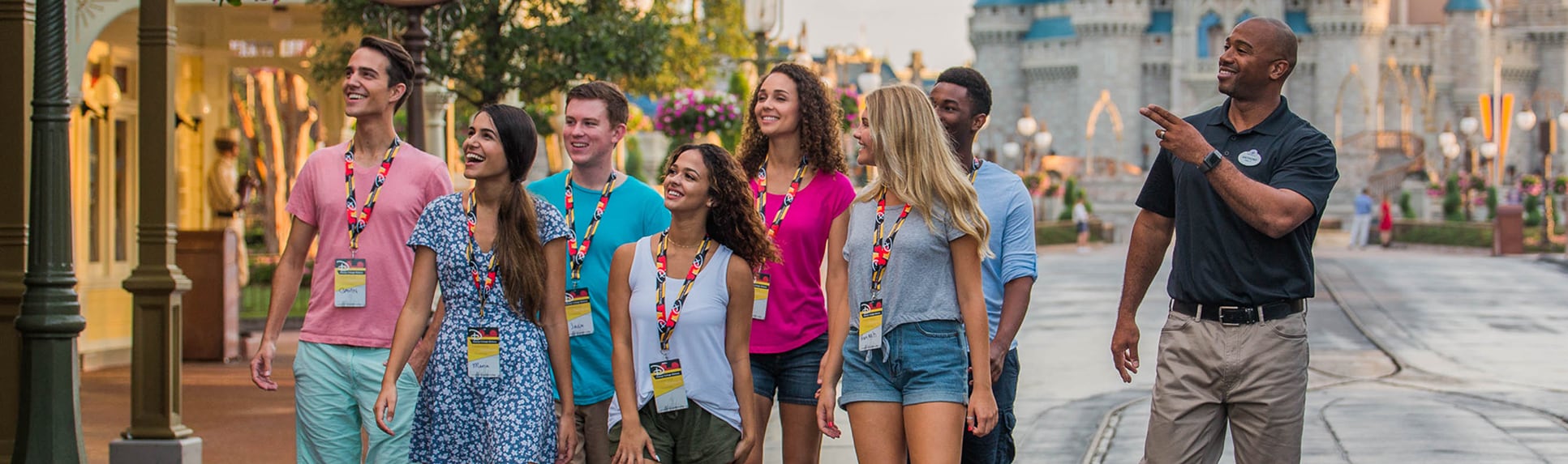 A Disney Cast Member leading a group of young adults through Magic Kingdom Park